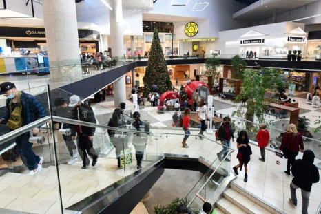 People shop at a mall in Santa Anita, California on December 20, 2021