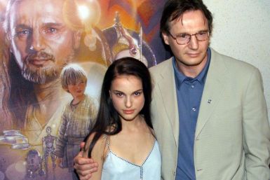 Actress Natalie Portman and actor Liam Neeson pose for photographers as they arrive at the New York .. 