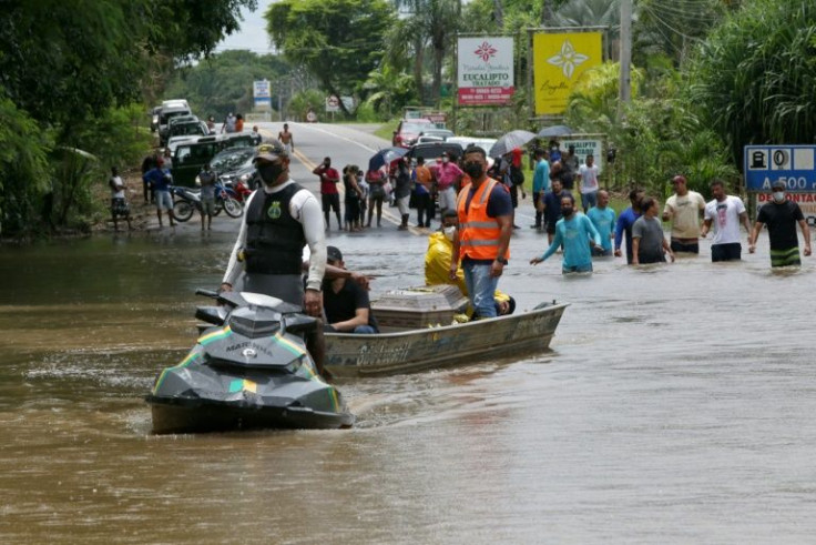 A member of the Navy helps transport items during flooding in Ilheus, located in Brazil's Bahia State, on December 27, 2021