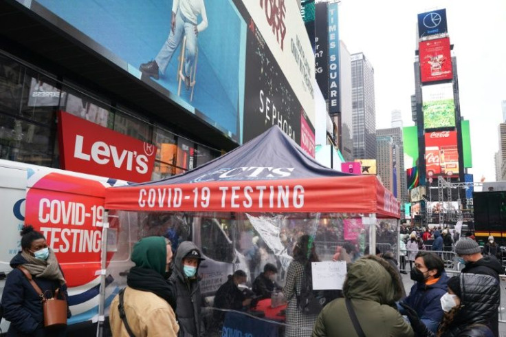 People stand in line for a Covid-19 test at a mobile testing site in Times Square on December 28, 2021 in New York