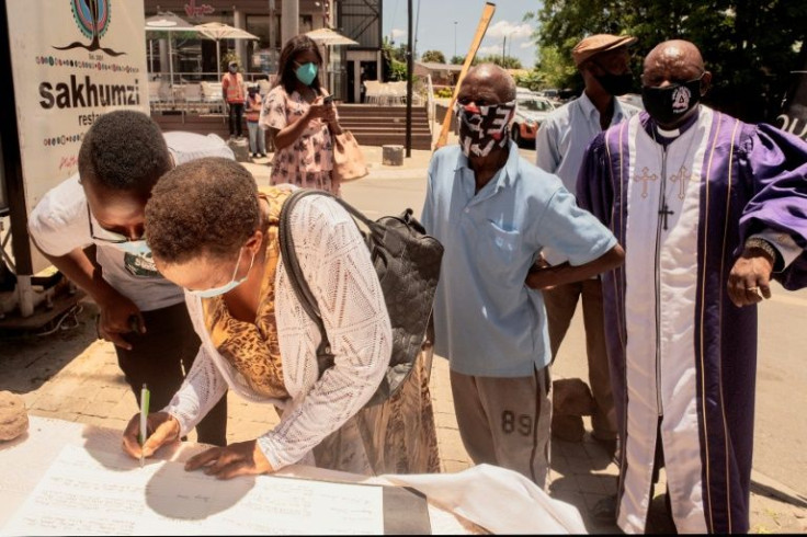 Devotees sign a book of remembrance for Tutu, the Nobel Peace Prize laureate and giant of the struggle against apartheid who passed away on December 26 aged 90