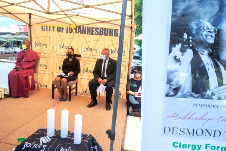 Johannesburg Anglican Bishop Stephen Moreo sits on stage with Johannesburg mayor, Mpho Phalatse (C), who paid tribute to Tutu's boldness in confronting South Africa's apartheid-era problems
