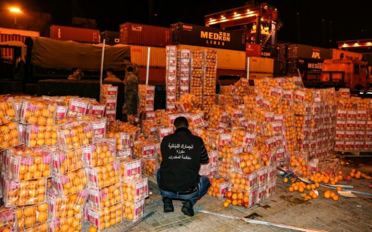 A Lebanese customs agent checks boxes of oranges, in which fake fruit filled with the illegal stimulant Captagon were hidden among real fruit