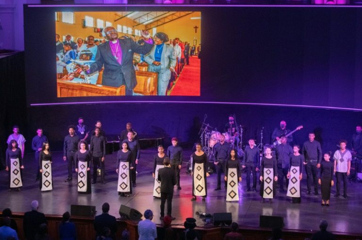The South African Youth Choir perform at the event in front of an image of the revered Archbishop