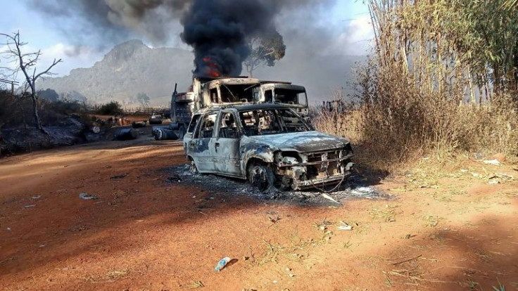 This handout image from the Karenni Nationalities Defense Force (KNDF) taken and released on December 25, 2021 shows burnt vehicles in Hpruso township in Kayah state