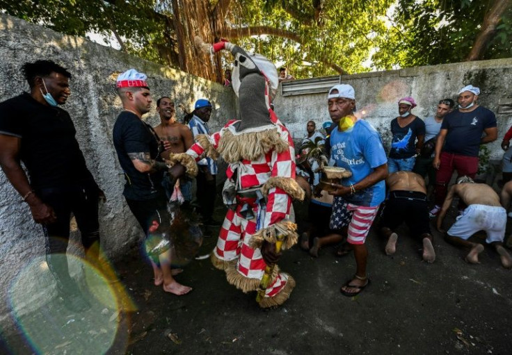 The Akabua Ireme -- little devil -- dances during the oath ceremony at the Efi Barondi Cama temple in Cuba