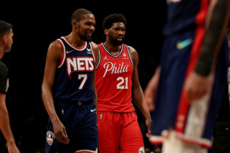 Philadelphia's Joel Embiid prepares to shoot a free throw as Brooklyn's Kevin Durant looks on in the 76ers' NBA victory over the Nets