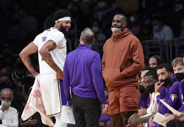 LeBron James #6 of the Los Angeles Lakers and Anthony Davis #3 talk with head coach Frank Vogel 