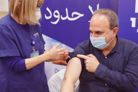An Israeli man receives a fourth dose of the Pfizer-BioNTech vaccine against Covid-19 at the Sheba Medical Center in Ramat Gan near Tel Aviv