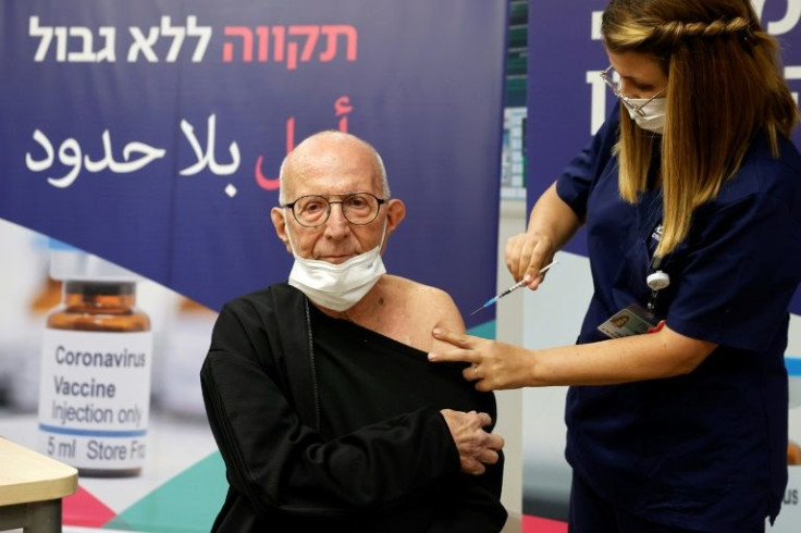 A man receives a fourth Covid jab at the Sheba hospital near Tel Aviv as Israel rolls out 4th booster shots for those with weakened immunity, residents of retirement homes and geriatric patients