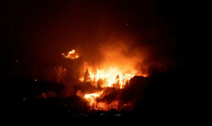 Flames engulf homes as the Marshall Fire spreads through a neighborhood in the town of Superior in Boulder County, Colorado on December 30, 2021