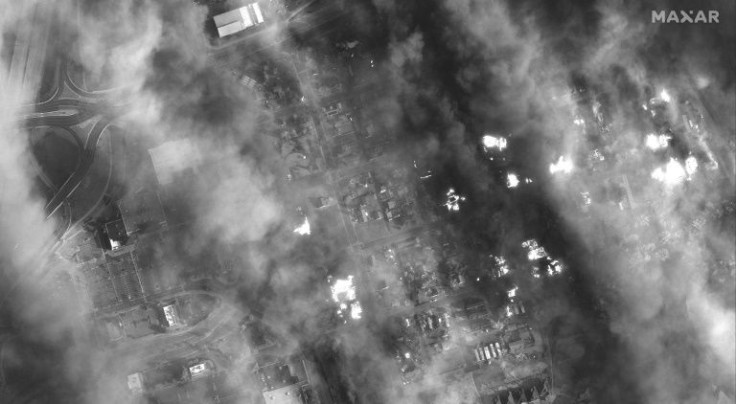 This handout black and white WorldView-1 satellite image released by Maxar Technologies shows homes and shopping center engulfed in smoke in Superior, Colorado