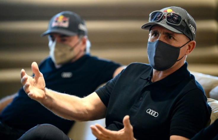 Record Dakar winner Stephane Peterhansel (R) and three-time champion Carlos Sainz say their Audi hybrid is not capable of winning this year.