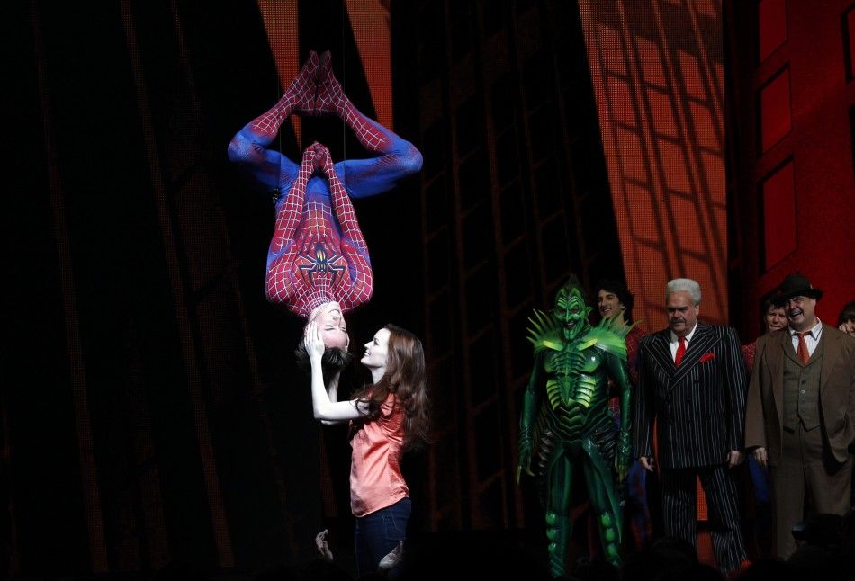Cast member Reeve Carney L is kissed by fellow cast member Jennifer Damiano C during the curtain call for the Broadway opening of quotSpider-Man Turn Off The Darkquot in New York June 14, 2011.