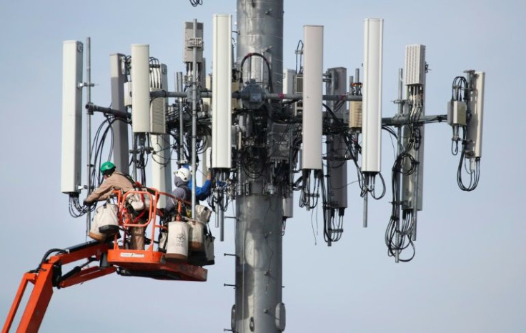 A Verizon crew updates a cell tower to handle the 5G network in Orem, Utah in December 2019