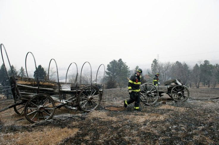 On Dec 31, 2021 firefighters walk near a home destroyed by a wildfire in Boulder County, Colorado
