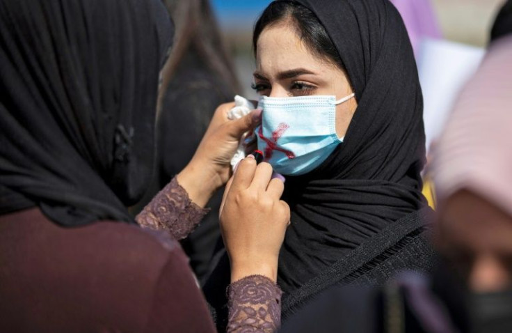 Demonstrators a March rally for International Women's Day in Iraq, as Islamist parties block parliament's endorsement of a draft law on domestic abuse
