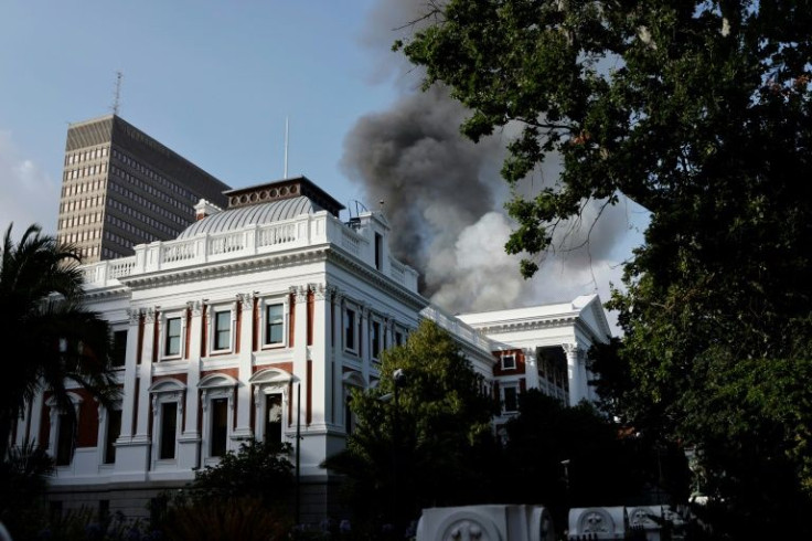 Smoke billows from the roof of a building at the South African Parliament precinct in Cape Town