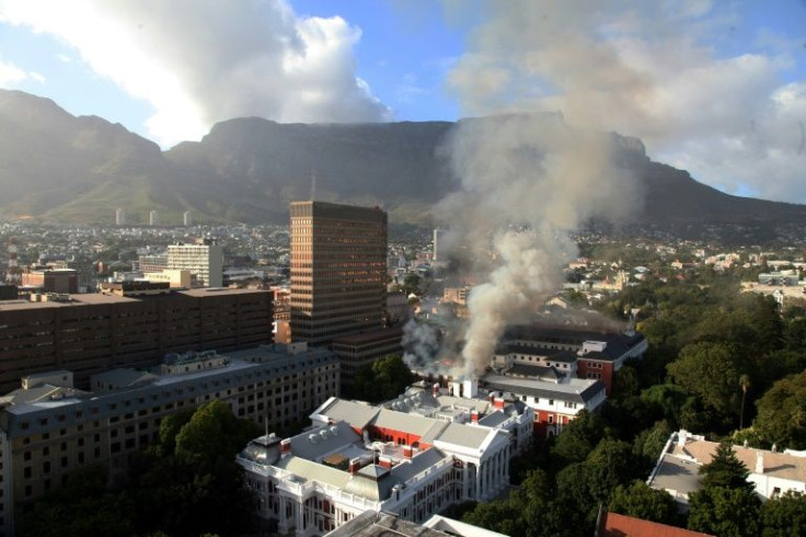 Smoke billows into the sky in Cape Town from a fire that broke out in South Africa's seat of parliament