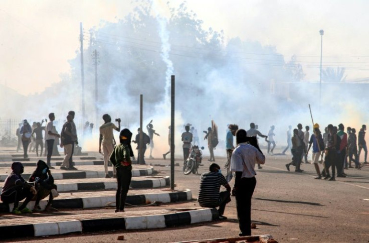 Sudanese protesters gather amid tear gas fired by security forces, during a demonstration against the October 25 coup, in the capital Khartoum, on January 2, 2022