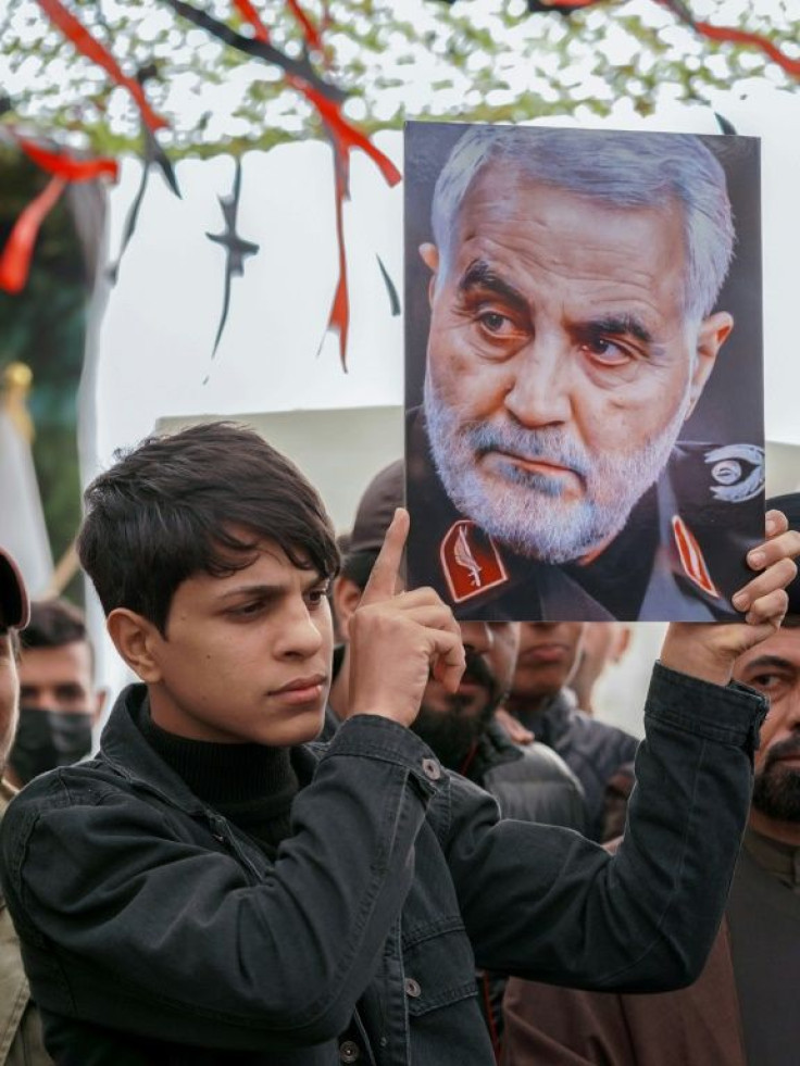 Mourners including members of Iraq's al-Hashed al-Shaabi ex-paramilitary alliance honour Soleimani in the central holy shrine city of Najaf on January 3, 2022