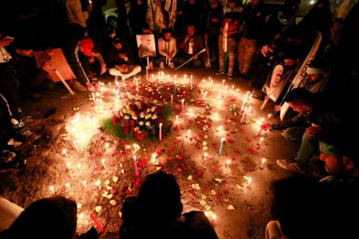 Iraqis light candles to remember the men killed near Baghdad's International Airport