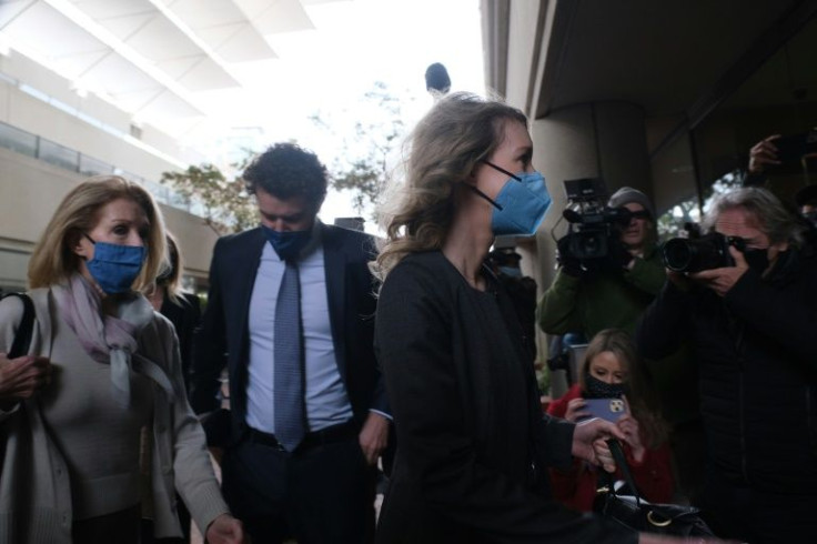 Elizabeth Holmes (C) enters the courthouse accompanied by her partner, Billy Evans (2nd L) and her mother (L) in her fraud trial in San Jose, California, January 3, 2022