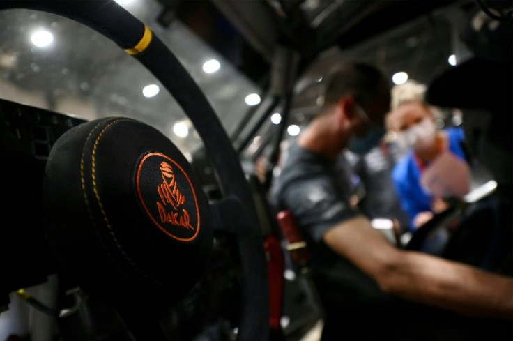 A competitor works on his car during a technical check-up in Jeddah, on December 30, 2021 ahead of the 2022 Dakar Rally
