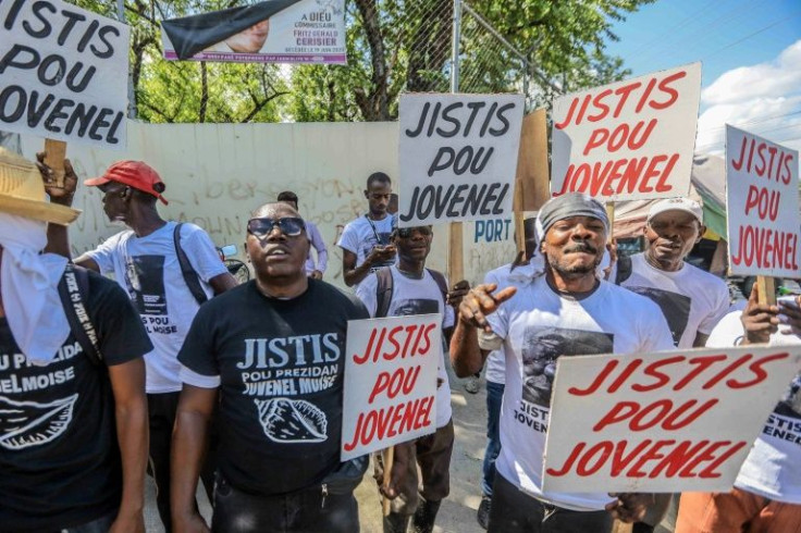 In this file photo taken in October 2021, a group of activists demands justice for slain Haitian president Jovenel Moise