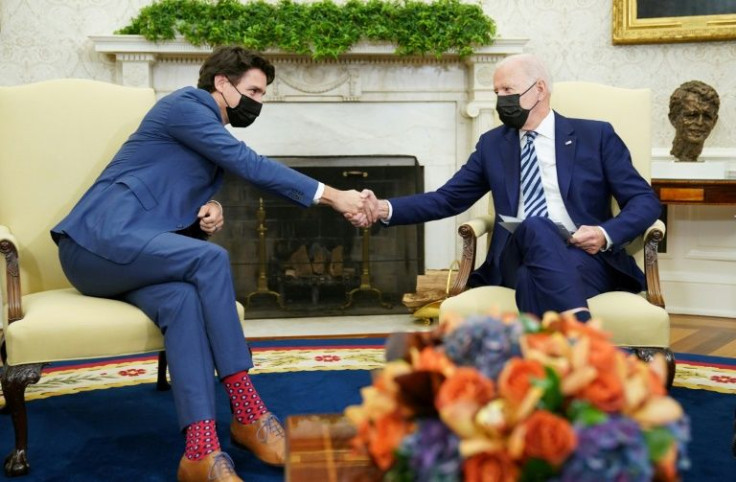 US President Joe Biden (right), shaking hands with Canada's Prime Minister Justin Trudeau (left), has tried to smooth trade relations between the neighbors, but frictions remain