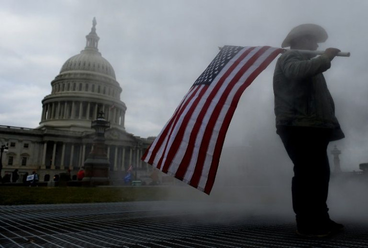 In this file photo taken on January 06, 2021, a supporter of US President Donald Trump holds a flag outside the US Capitol during the assault