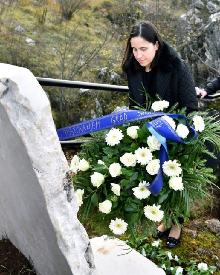Benjamina Karic, mayor of Sarajevo, lays flowers in November 2021 at a controversial new memorial plaque to Serbs killed during the siege of the city during the war