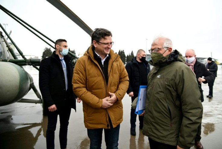 Ukrainian Foreign Minister Dmytro Kuleba (left) and top EU diplomat Josep Borrell speak prior to boarding a helicopter in Kharkiv ahead of their flight to the frontline of Kyiv's conflict with pro-Russia rebels