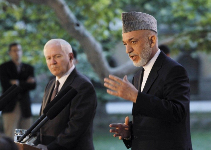 US Secretary of Defense Gates listens as Afghanistan's President Karzai speaks at a news conference in Kabu
