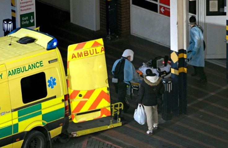 Paramedics unload a patient from an ambulance after arriving at Leeds General Infirmary hospital in Leeds, northern England on January 5, 2022; official data shows one in 15 people in England were infected with the coronavirus in 2021's final week