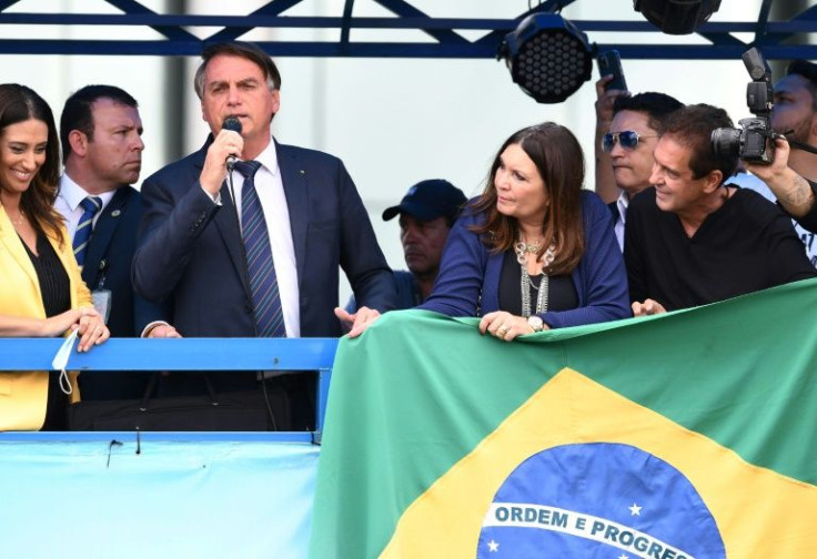 Swept to office by a broad swathe of voters fed up with economic collapse, corruption and crime, Brazilian President Jair Bolsonaro (C, pictured November 2021) ended up focusing on "moral restoration" instead of those issues