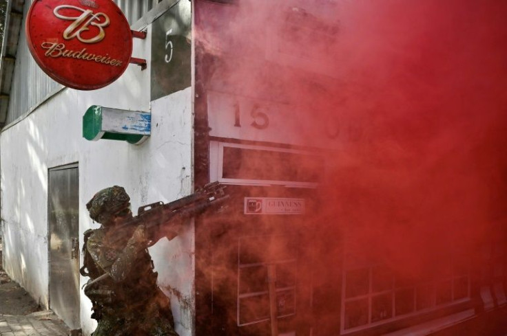 Taiwanese soldiers take part in a simulated urban battle to prepare for an invasion by China, which has long vowed to take the island