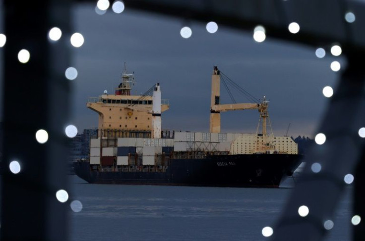 A container ship sits anchored in Vancouver Harbour near the Port of Vancouver on November 20, 2021 -- flooding in British Columbia halted railway access to the port, affecting exports
