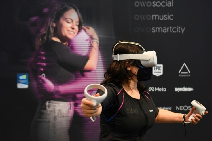 An attendee demonstrates the Owo vest, which allows users to feel physical sensations during virtual reality experiences including wind, gunfire or punching, at the Consumer Electronics Show (CES) in Las Vegas, Nevada