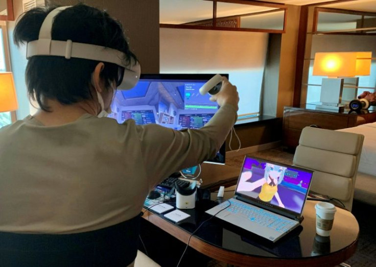 Takuma Iwasa, Shiftall CEO, demonstrates the Haritora X, a full body tracking system for virtual reality, at the Consumer Electronics Show (CES) in Las Vegas, Nevada
