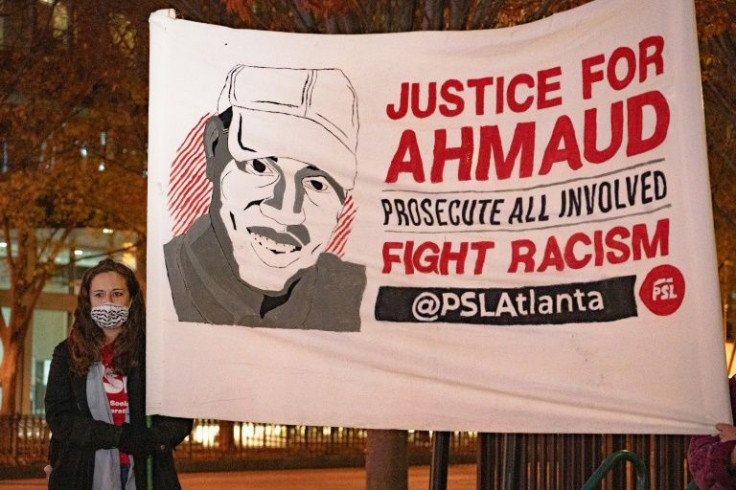 People participate in a vigil in Atlanta, Georgia after three white Georgia men were convicted of murdering African-American Ahmaud Arbery.