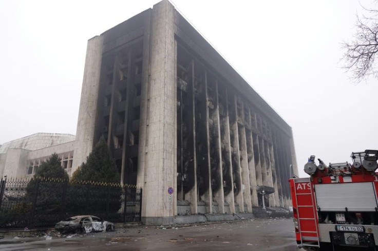 Shattered glass and burnt-out cars littered Almaty's streets which were enveloped in an eerie mist