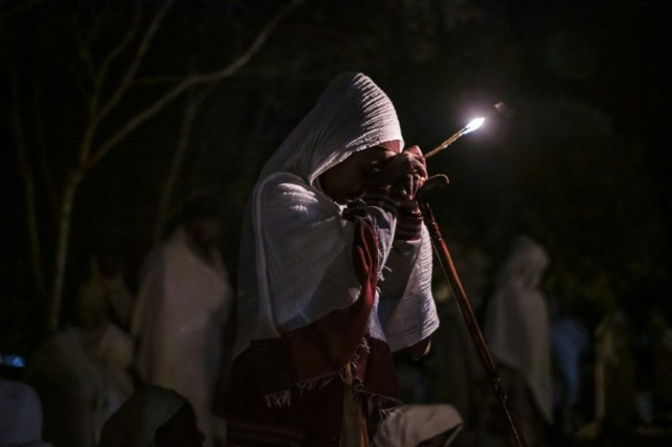 A pilgrim holds a candle at St. Mary's Church. Lalibela has changed hands repeatedly during Ethiopia's bloody conflict