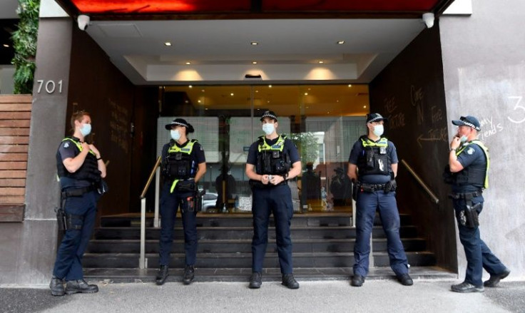 Police stand guard at the government detention centre in Melbourne where Djokovic is staying