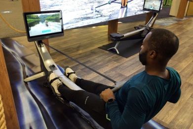 Aquil Abdullah, an employee of the Hydrow rowing fitness company, demonstrates a rowing machine at the CES technology show in Las Vegas on January 7, 2022