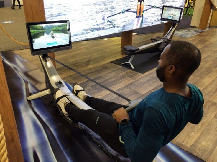 Aquil Abdullah, an employee of the Hydrow rowing fitness company, demonstrates a rowing machine at the CES technology show in Las Vegas on January 7, 2022