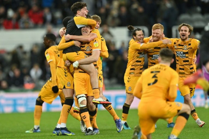 Cambridge United's players celebrate beating Newcastle 1-0 the FA Cup third round