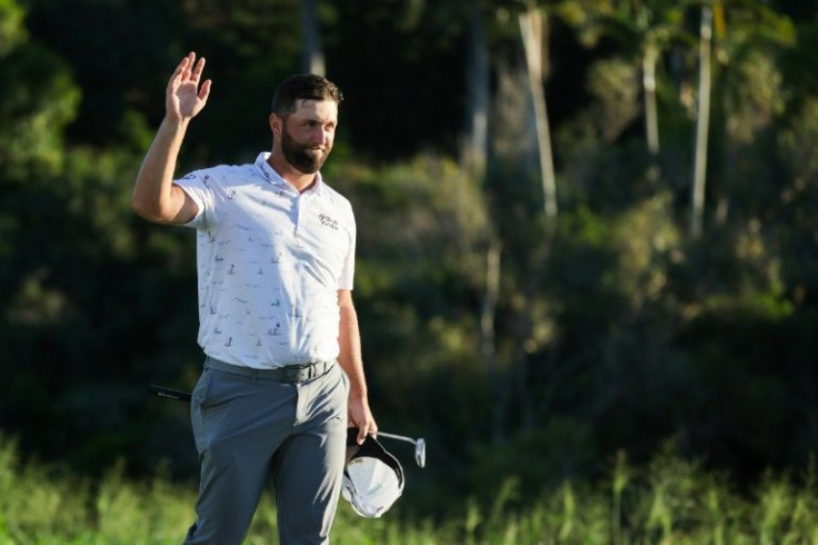 World number one Jon Rahm acknowledges fans after putting to tie the course record and take share of the third-round lead in the PGA Tour Tournament of Champions