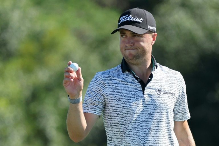 American Justin Thomas waves after putting on the 18th green in his course record-breaking 61 in the third round of the PGA Tour Tournament of Champions