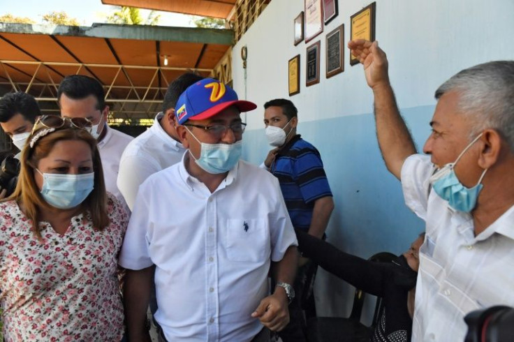 Opposition candidate Sergio Garrido (C), is greeted by a supporter after voting during the rerun of the gubernatorial election in Barinas, Venezuela, on January 9, 2022
